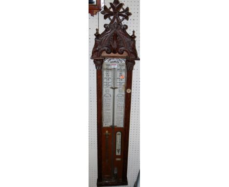 A late Victorian carved oak cased Admiral Fitzroy barometer, having typical signed silvered scale with further thermometer be