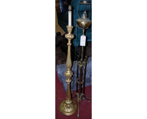 An Art Nouveau pierced brass telescopic standard lamp; together with a giltwood example (2) 