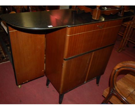 A 1970s bow front bar having a faux granite top above a fall front with cupboards below, on tapered supports, width 158cm