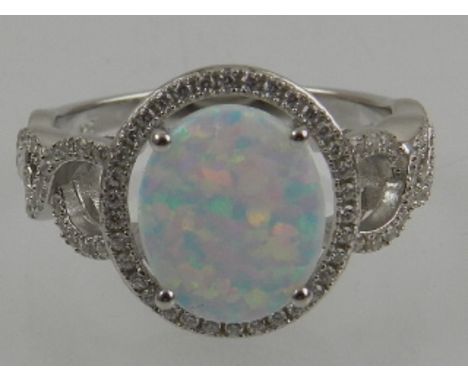 A silver, CZ, and opalite set cocktail ring. 