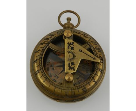 A novelty brass hand-held compass and sundial. 