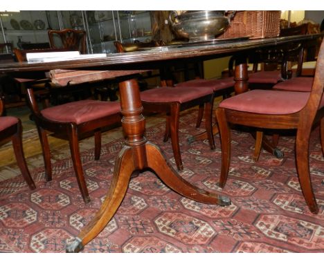 A Regency style dining suite, comprising a mahogany and brass inlaid D-end extending (two leaves) dining table, raised on twi