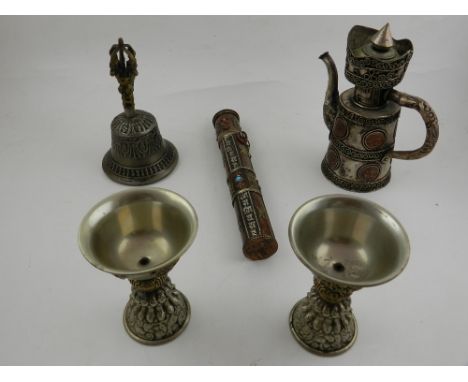 A collection of white metal Middle Eastern items, to include a teapot, a bell and two ceremonial cups, and a scroll holder.