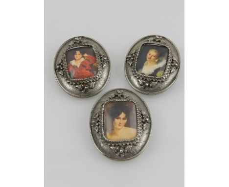 Three white metal oval portrait brooches. 