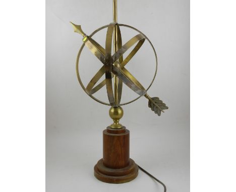 A brass lamp stand, in the form of a weather vane, raised on a stepped wooden base, together with a plaster lamp, raised on a