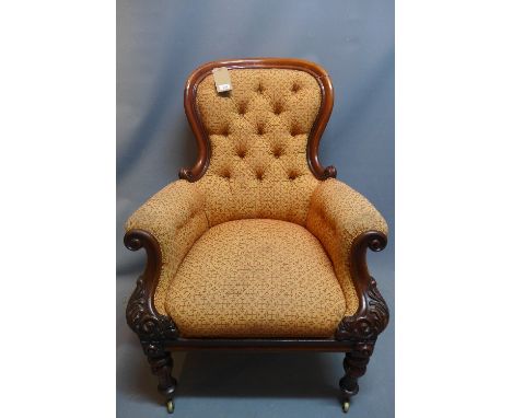 A William VI mahogany arm chair with button back upholstery raised on carved legs and castors.