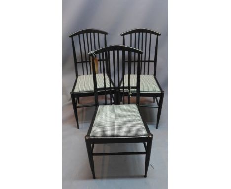 A set of three 'Asko' ebonised stick back dining chairs. 