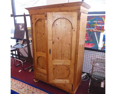 A 20th Century pine wardrobe having reed columns with two doors over single drawer, raised on bracket feet. H-178cm, W-121cm,