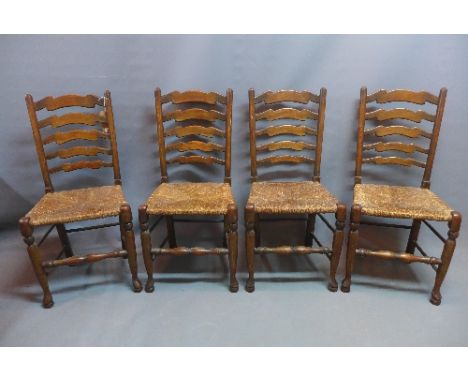A set of four 19th Century ladder back oak dining chairs. 