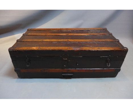 An early 20th Century travelling trunk bearing a Louis Vuitton label inside. H-31cm, W-92cm, D-47cm 