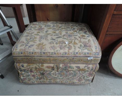A modern upholstered pouffe/ottoman