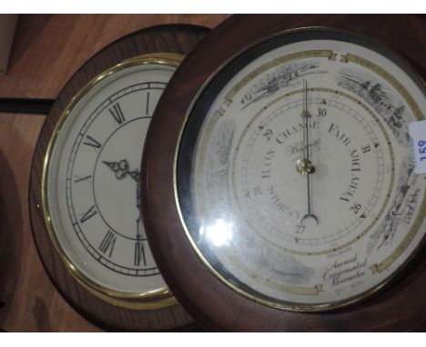 A wall clock and barometer 