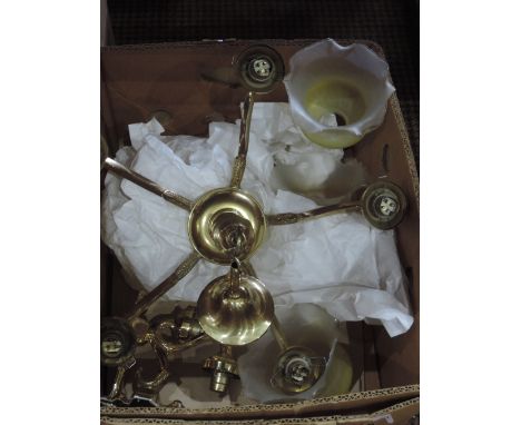 A brass light fitting with glass shades