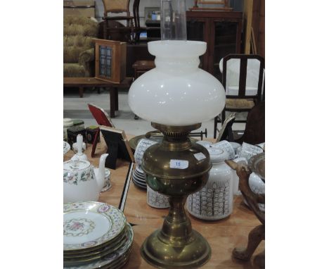 A brass oil lamp with glass shade and chimney 