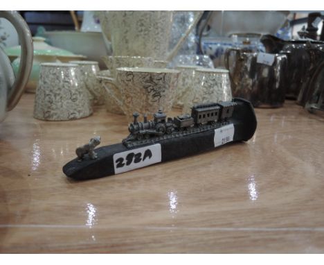 A vintage rail spike with model train and bear decoration