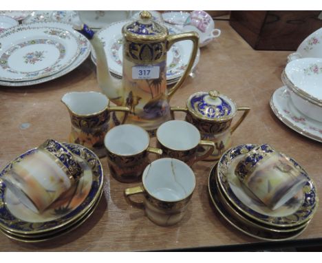 A Noritake coffee service dessert print with gilt and blue decoration