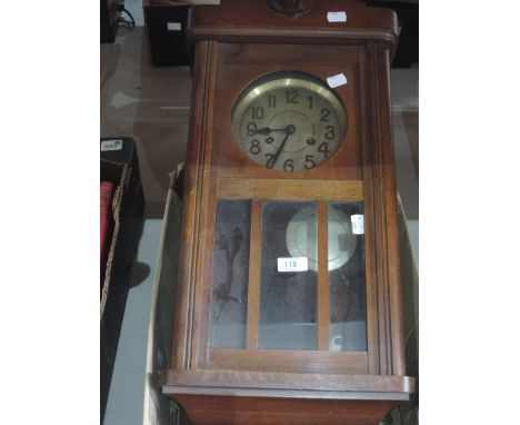 A vintage wooden cased wall clock