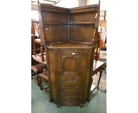 An oak floor standing corner cupboard, carved throughout, by Webber Furniture Company, The London Range; a corner wall hangin