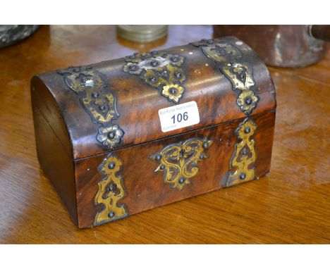 A dome topped walnut veneered tea caddy, pierced brass mounts, hinged cover, two partitions, circa 1850.