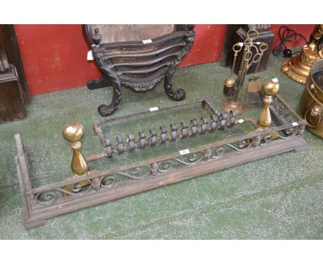 An early 18th century brass fender; a fire grate and companion set