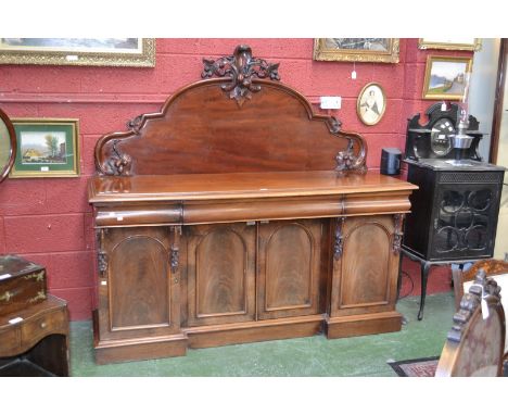 A Victorian mahogany sideboard, shaped cresting gallery carved with fruiting vines, moulded top, one long drawer to frieze, i