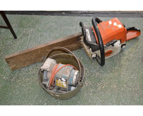 A Stihl MS290 petrol chainsaw; a Black and Decker sharpening stone; a brass cooking pot (3)