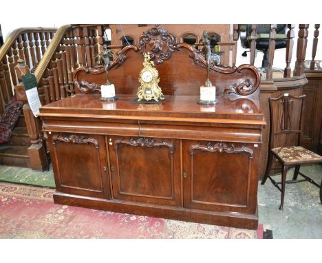 A Victorian mahogany sideboard, shaped and carved gallery, two long drawers to frieze over three panel door cupboard plinth b