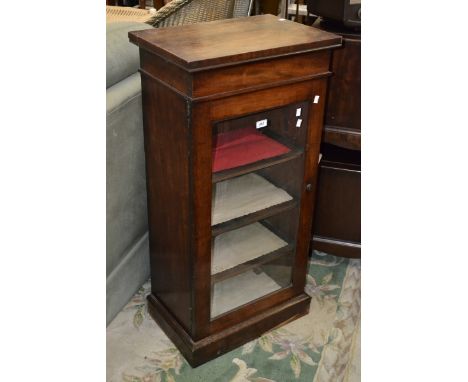 A Victorian mahogany music cabinet with glazed panel door, cites 1880.