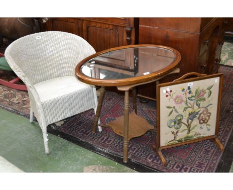 A Lloyd Loom chair; an Edwardian mahogany oval mirror; a firescreen; an oak occasional table