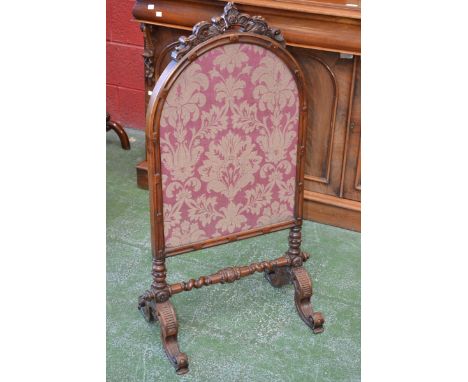 A Victorian carved walnut dome top fire screen, gilt tapestry panel, carved arched crest, turned columns & cross stretcher, s