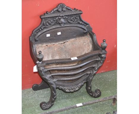 A cast iron fire grate, urnular finials