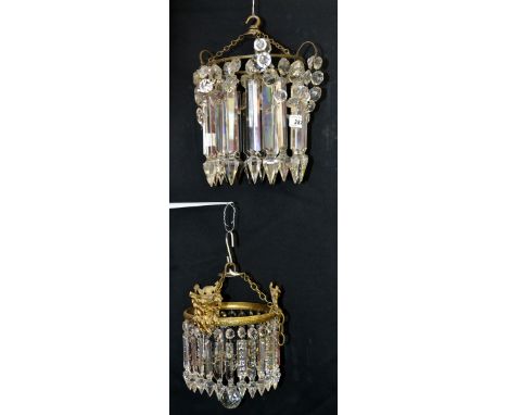 A 19th century cut crystal glass ring chandelier, brass ring, suspending tapering triangular and round drops, c.1840;  anothe