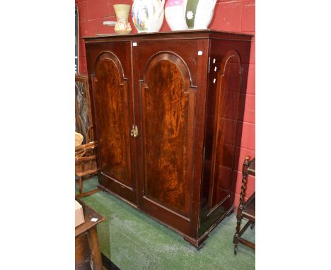 A flame mahogany gentleman's wardrobe, fielded arched panel doors. circa 1900.
