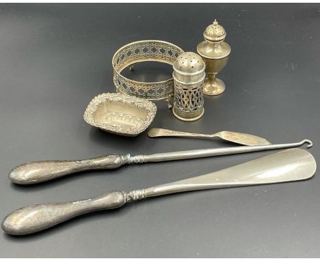 A collection of silver items to include, cruets, pin dish, silver handled shoehorn and button hook, etc.