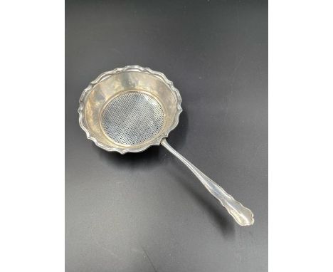 A silver tea strainer by William Hutton &amp; Sons Ltd, hallmarked for Birmingham 1928