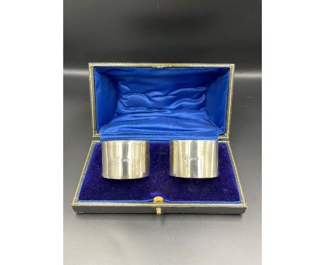 A boxed pair of silver napkin rings by William Hutton &amp; Sons Ltd, hallmarked for Birmingham 1945.