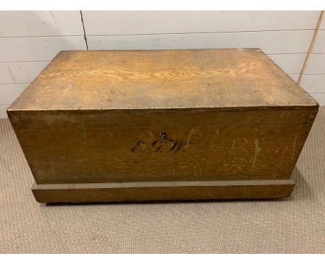 A wooden storage trunk with metal handles to sides and key (H47cm W98cm D56cm)