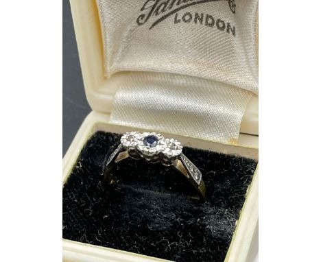 An 18ct gold and platinum set sapphire ring with diamond shoulders.