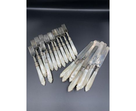 A Ten piece setting of silver knives and forks with mother of pearl handles. Hallmarked for Sheffield 1878 by Harrison Brothe