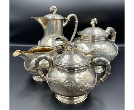 A Four Piece 19th/20th Century Silver tea Service by Tuck Chang and Co, in original box with Dragon and bamboo design.