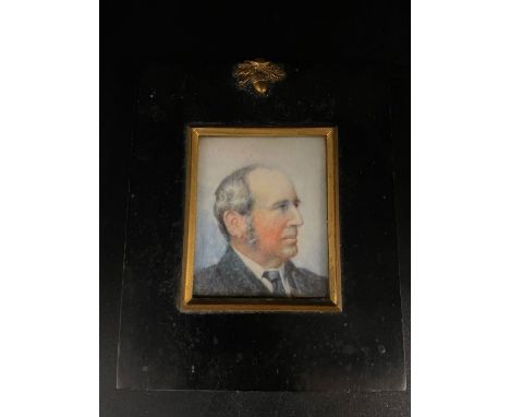 A miniature portrait of a gentleman in a black frame