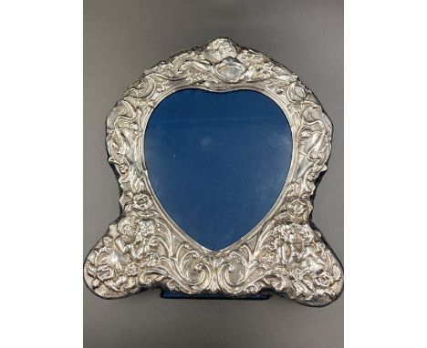 A silver heart shaped photo frame with easel back, hallmarked for Sheffield 1992 by Carr's of Sheffield Ltd