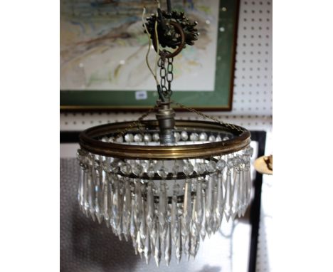 A two-tier crystal bag chandelier and a table lamp