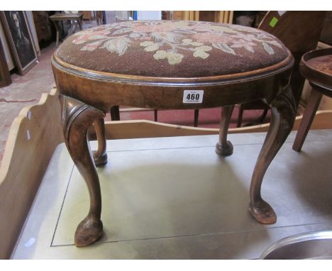 An early 20th Century walnut oval stool with tapestry seat on cabriole legs and pad feet bearing plaque 'Tozer 25 Brook Stree