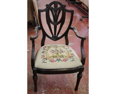 A set of four George III style mahogany dining chairs each with shield back and tapestry seat 