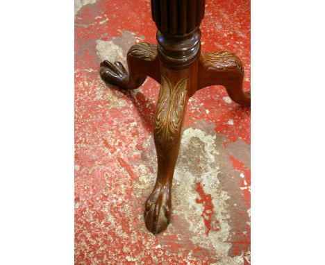 A George III style mahogany torchere with reeded column on carved tripod base and ball and claw feet 