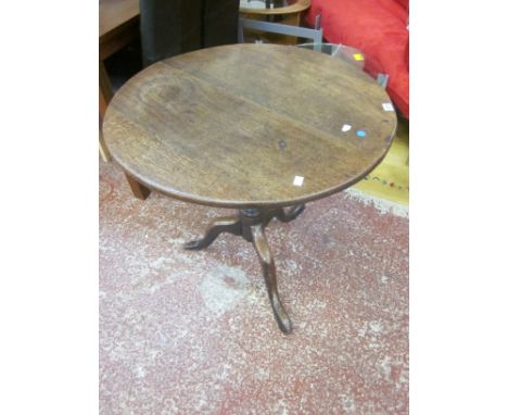 A George III oak tripod table on turned stem and splayed legs and pad feet 77cm diameter