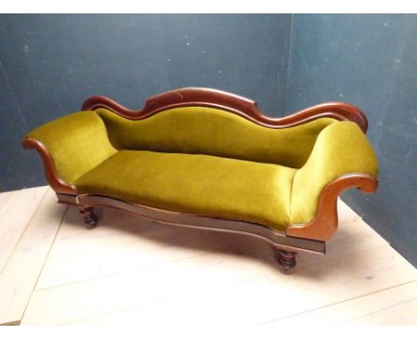 Victorian mahogany framed sofa on turned legs, upholstered in green velvet fabric