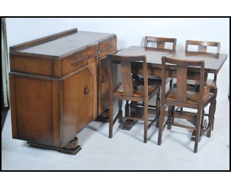 A 1940's post war Art Deco dining room suite comprising an oak draw leaf refectory dining table together with a set of 4 matc