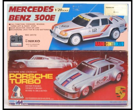 Two vintage battery operated remote control cars to include; Nikko made 1/20 scale Mercedes Benz 300E &amp; sonic controlled 